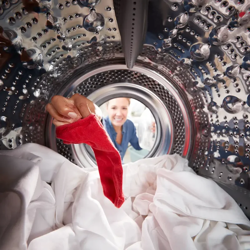 Wide lens photo of the interior of a dryer with laundry in it