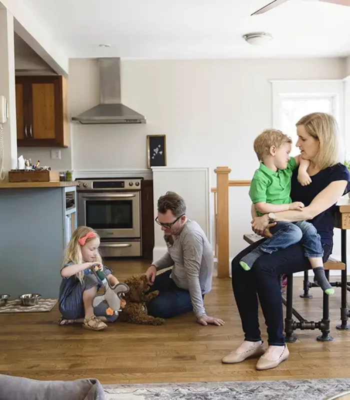 a man and woman sitting on a chair with children