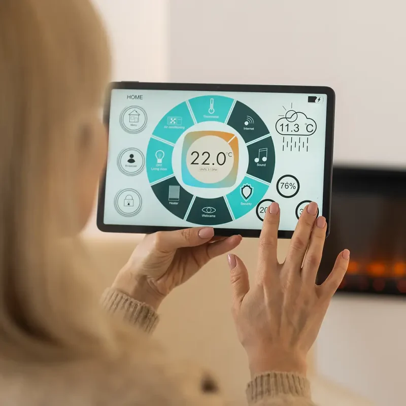 Lady using a digital thermostat