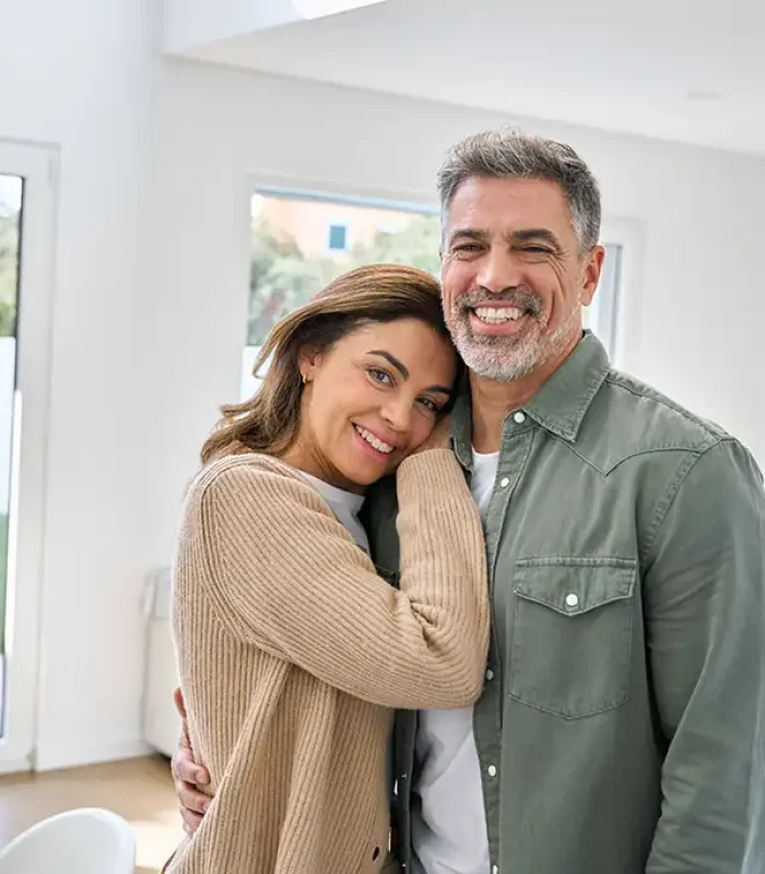 a man and woman hugging in a room
